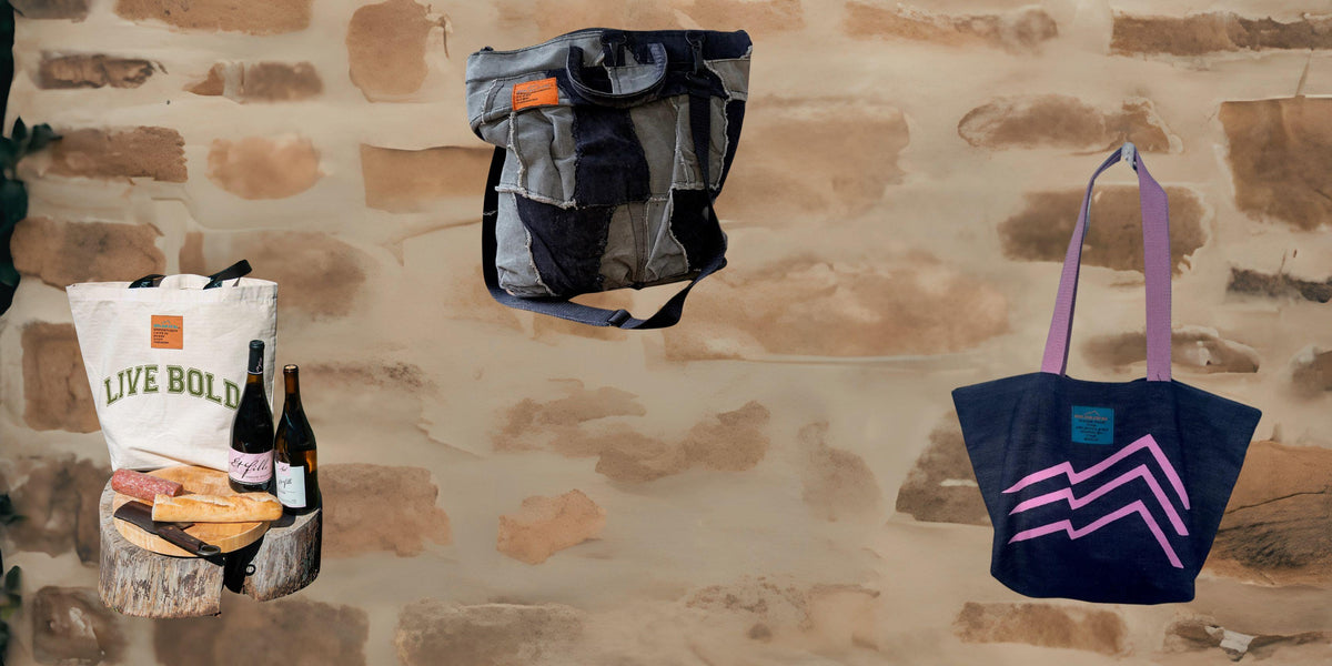 tote bags on a brick wall